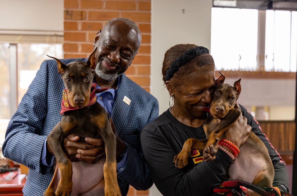 President and Mrs Brown holding their dogs named Crimson and Pipers