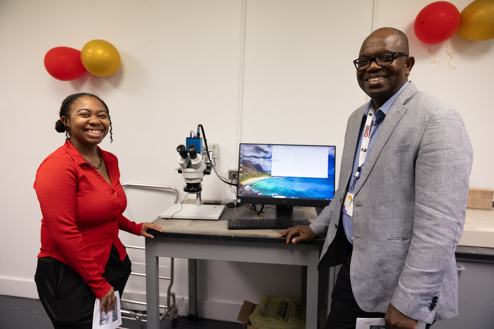 Department head and student standing near lab equipment