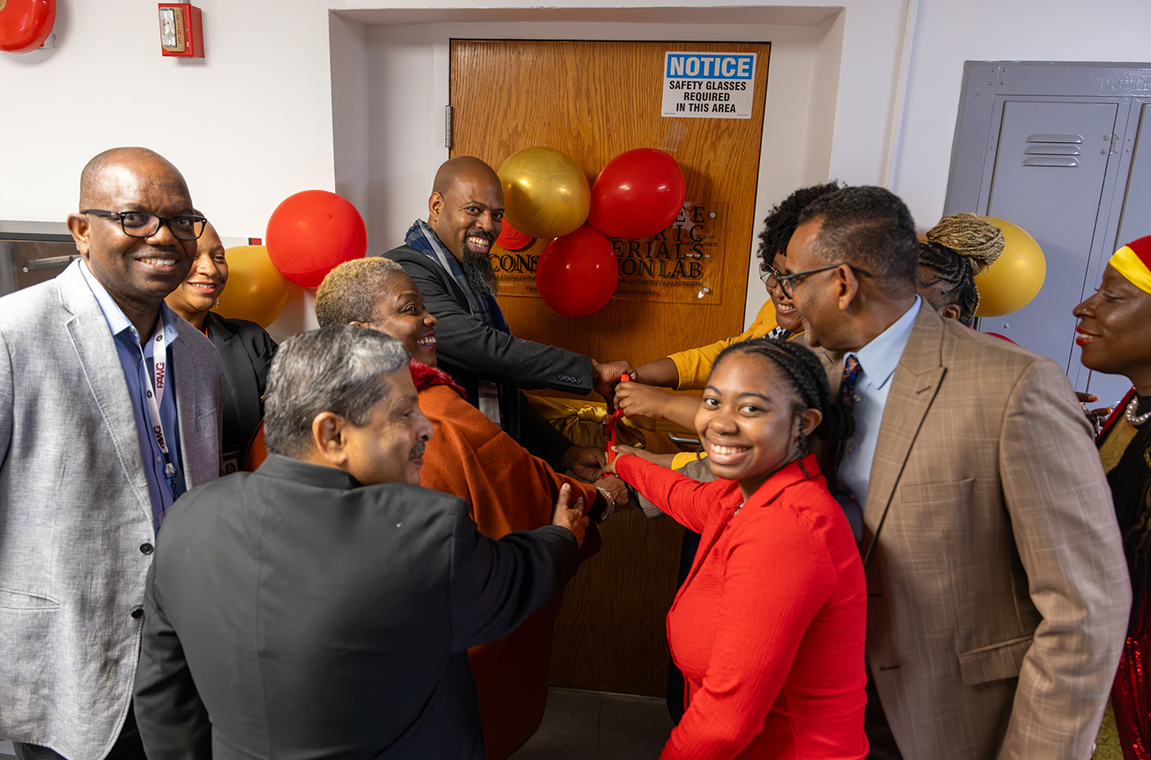 Department heads, students and administrators cutting the ribbon on the new lab
