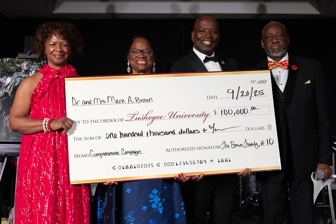 Dr. and Mrs. Brown presenting donation check to Board of Trustees