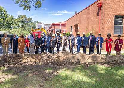 Officials with shovels break ground on new building