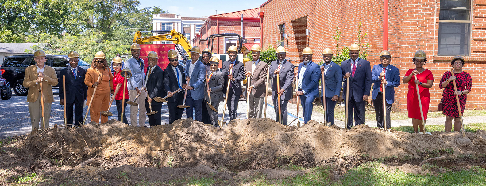 Officials with shovels break ground on new building