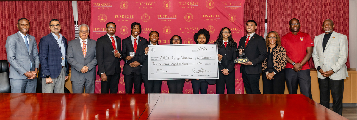 AMIE students with check