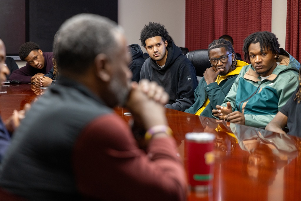 MBB players seated around the table during meeting with Dr. Brown_pic4