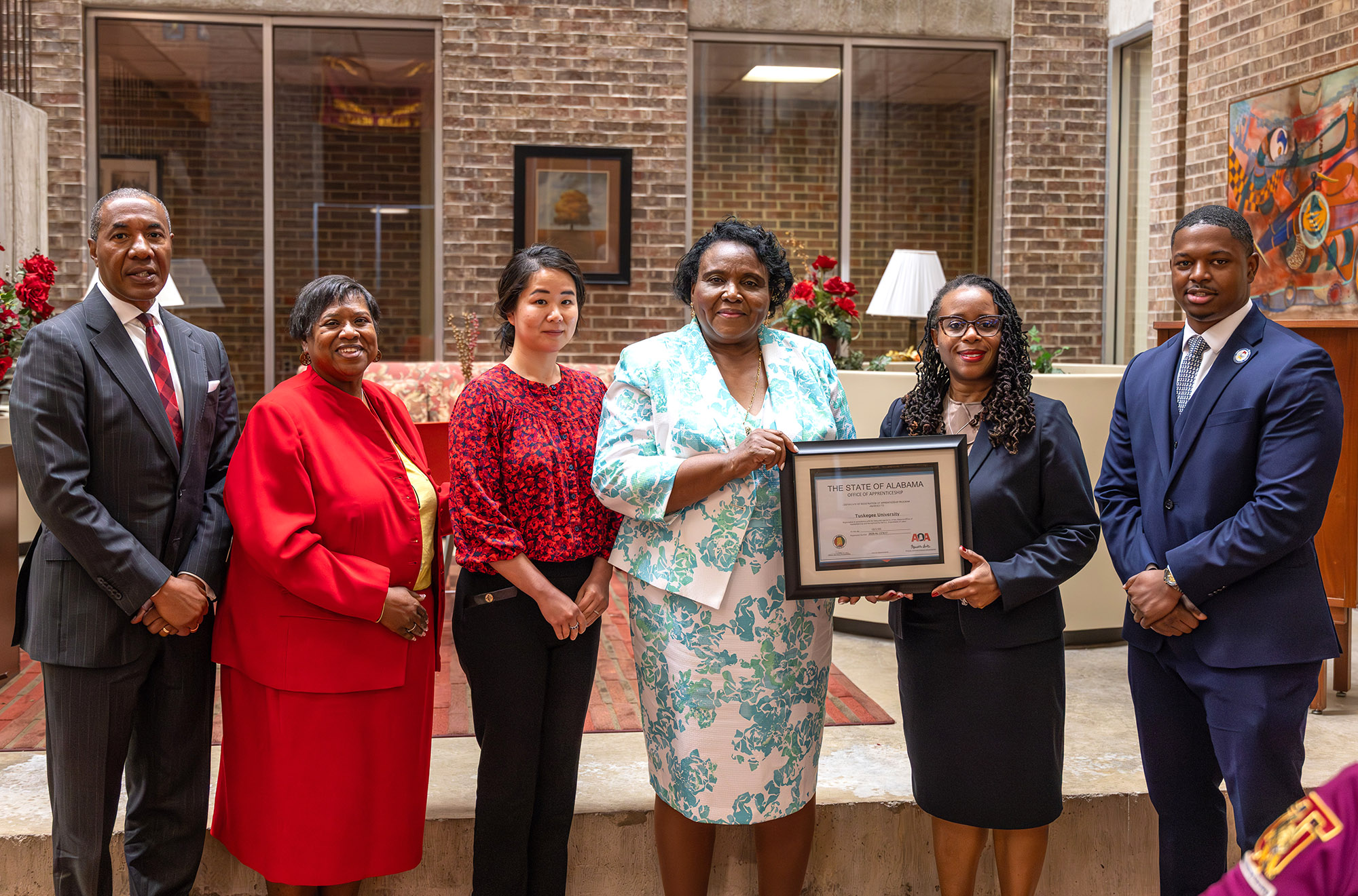 Dean Cornelia Nnedu, Trustee Henry Davis, and representatives of the State Office of Apprenticeship