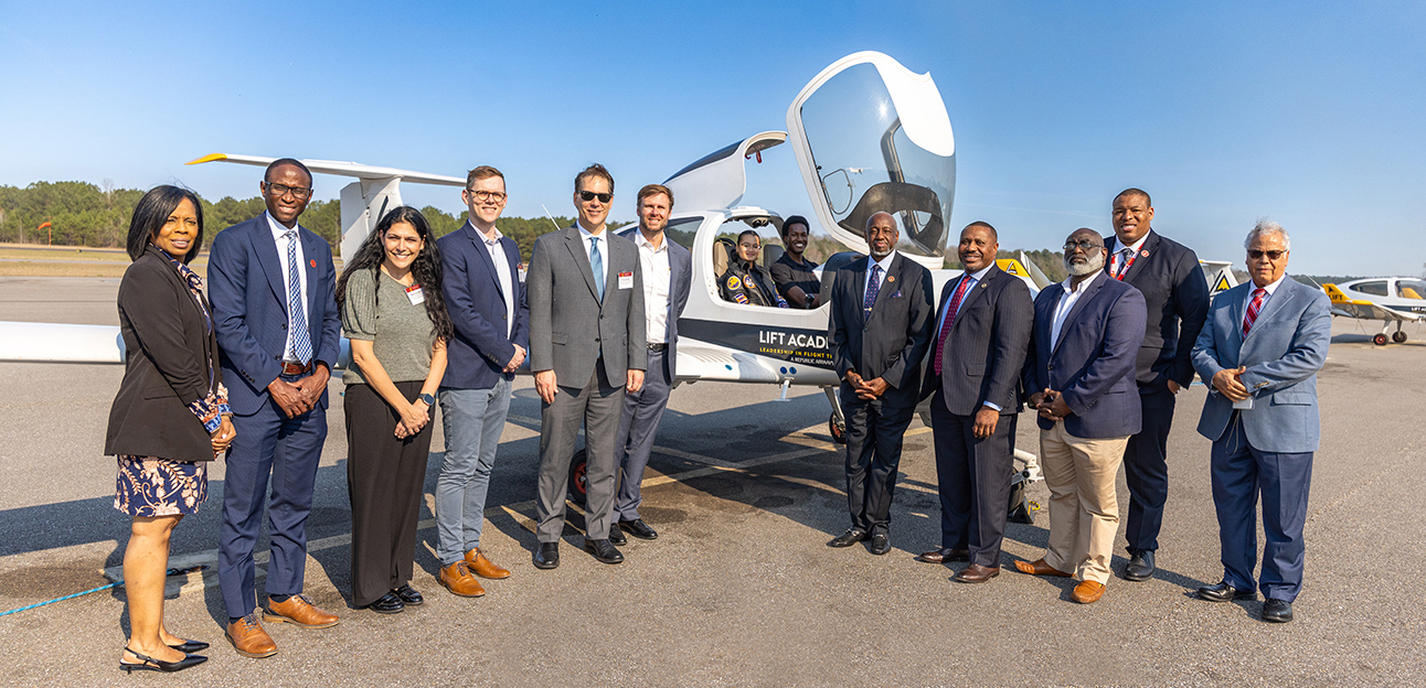 Tuskegee University Officials with Airbus officials standing at airplane 