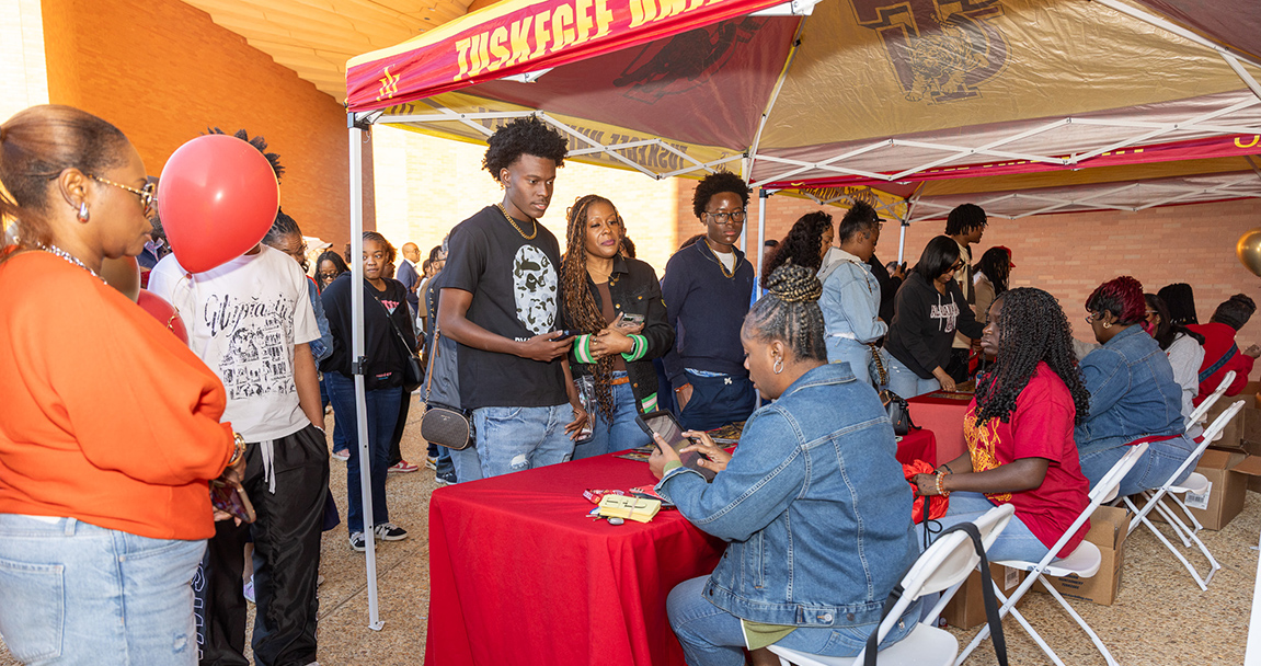 Students and parents signing in at tables