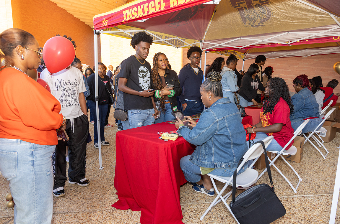 Students and parents signing in at tables