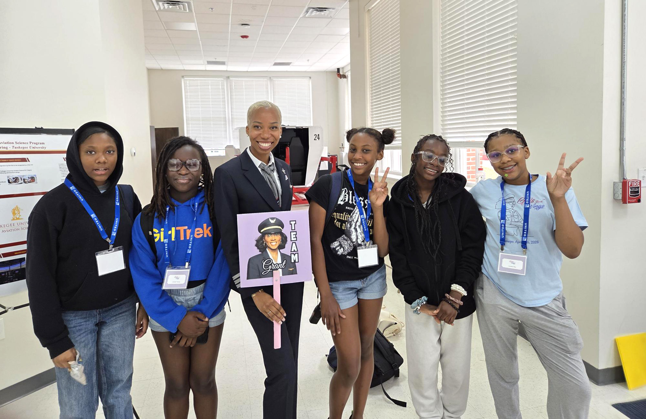 Makeda Dawson, an American Eagle pilot, poses with students