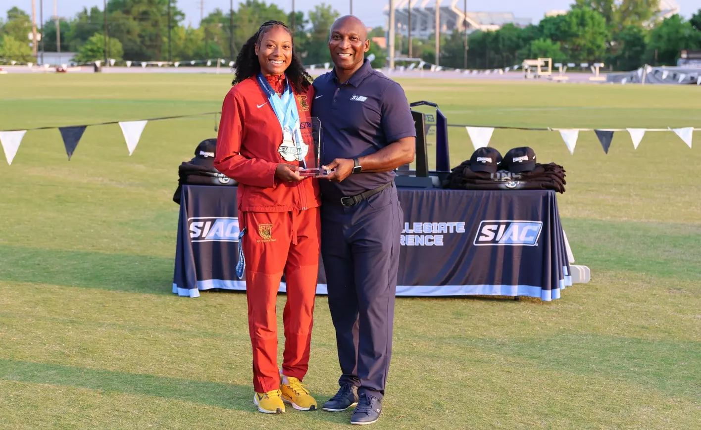 Commissioner Anthony Holloman presents award to Tuskegee