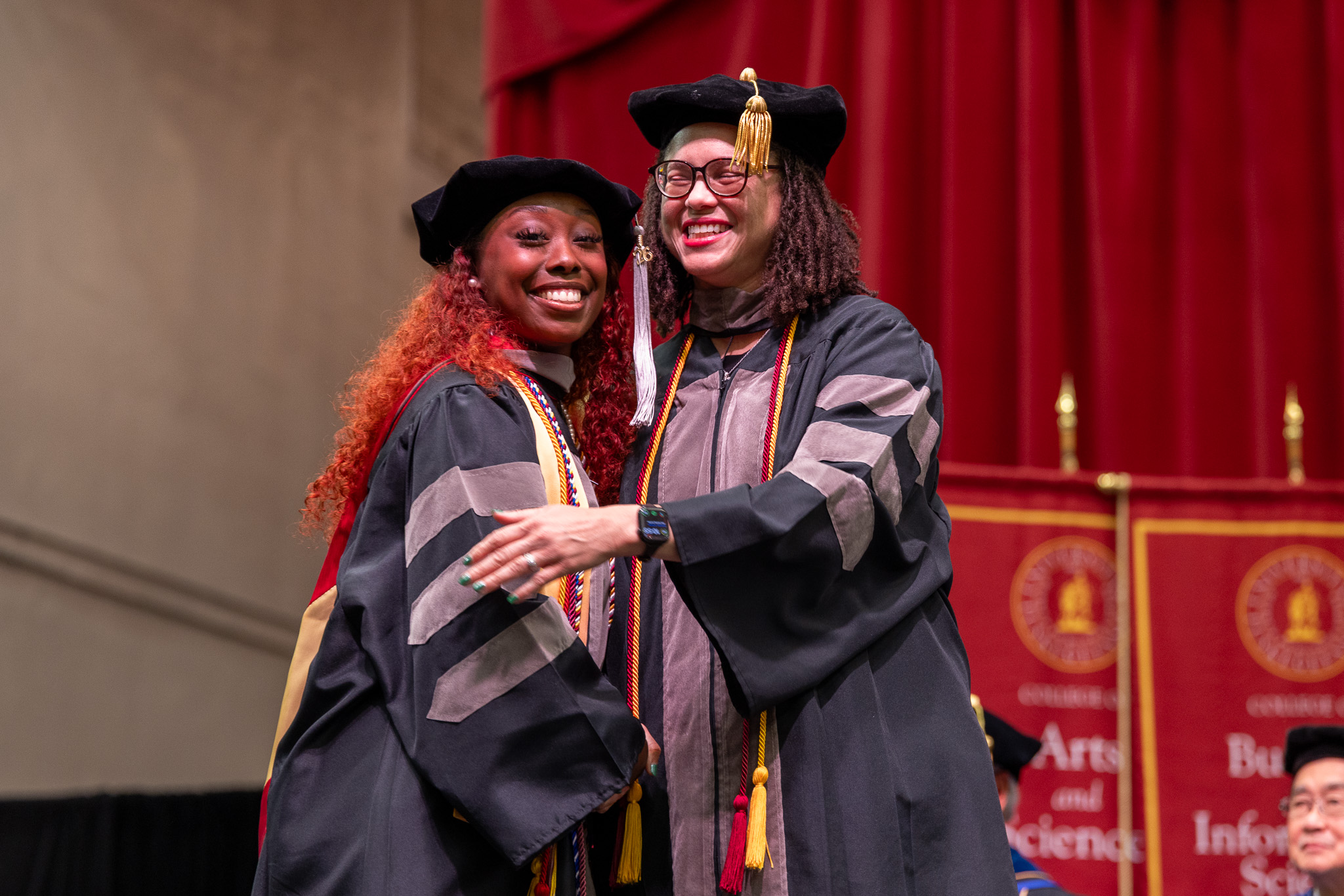 2026 Grad Commencement student hugs Dean