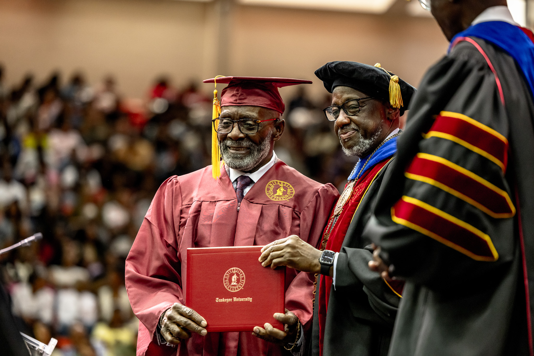 An older graduate who returned to college after many years receives his degree