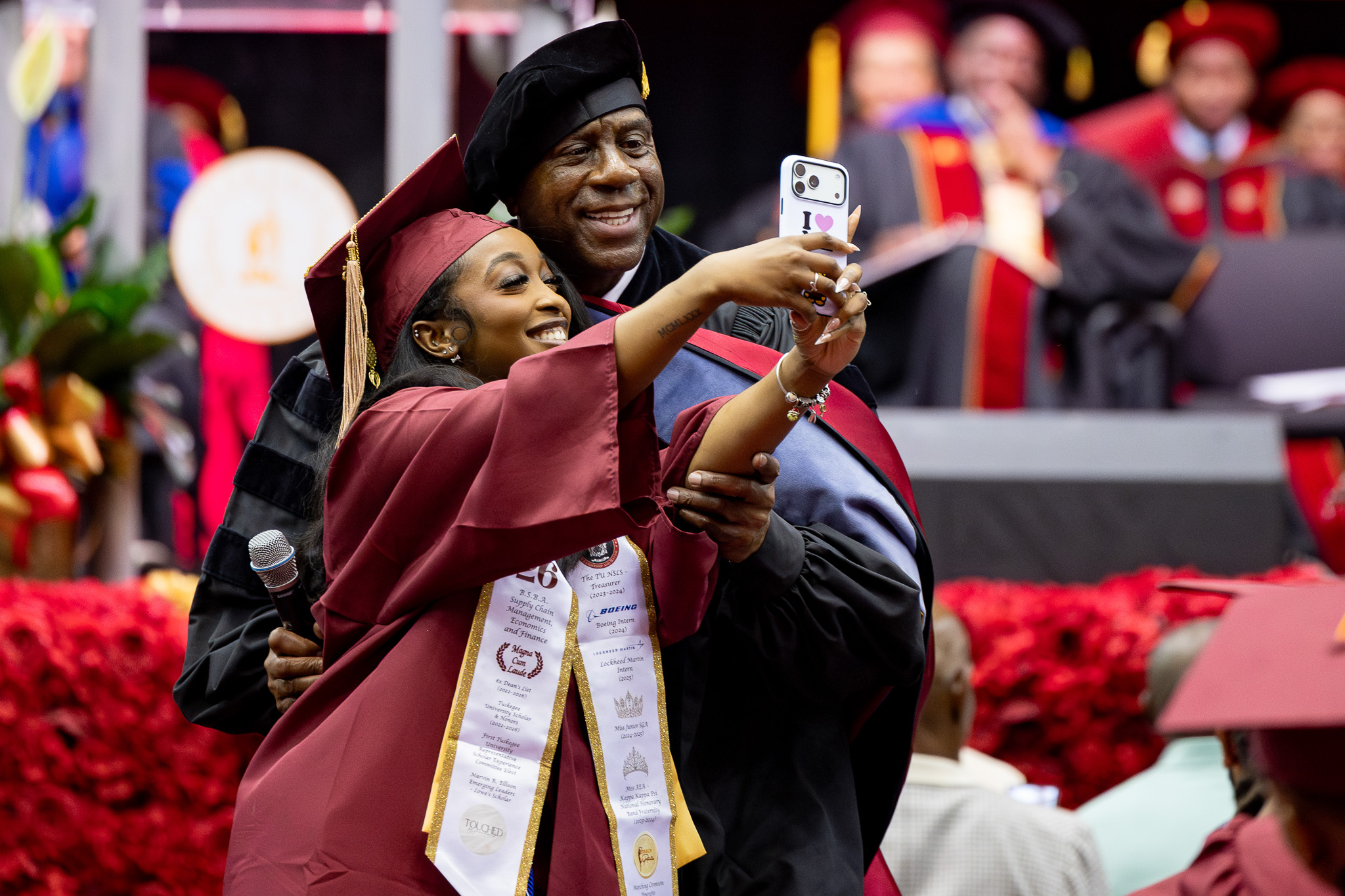 Female student takes selfie with Magic Johnson, who used her phone for demonstration