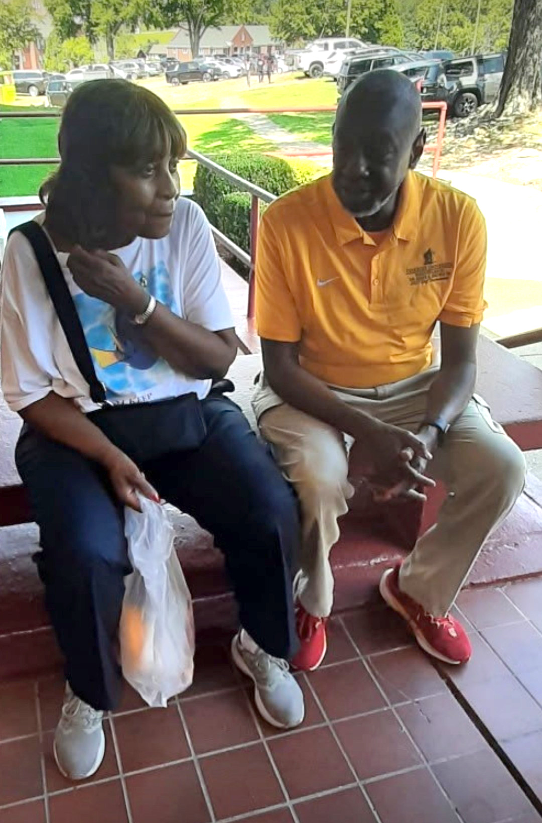 Dr. Mark A. Brown sits and chats with a grandparent
