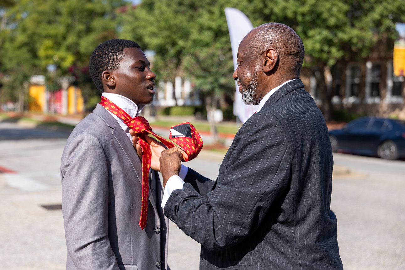 Dr. Brown helps new student with his tie