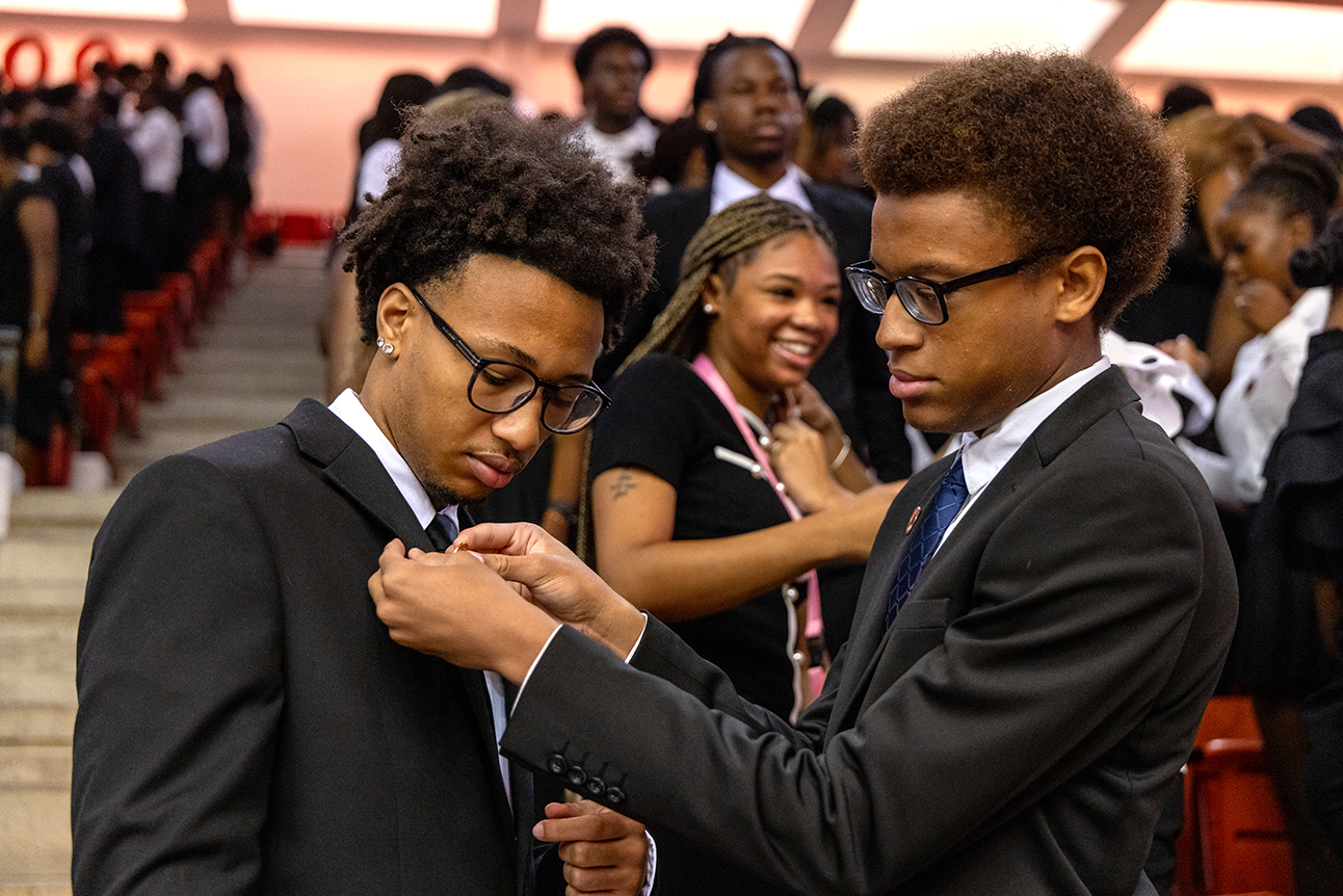 A new student pins his friend