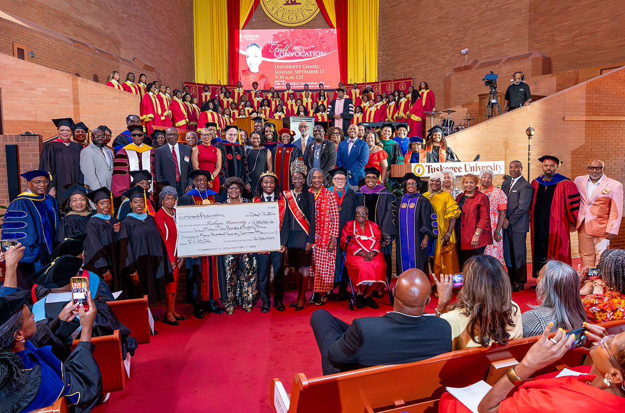 Eminent Associates present $4.1 million check for the university to Dr. Mark A. Brown during Fall Convocation 2026