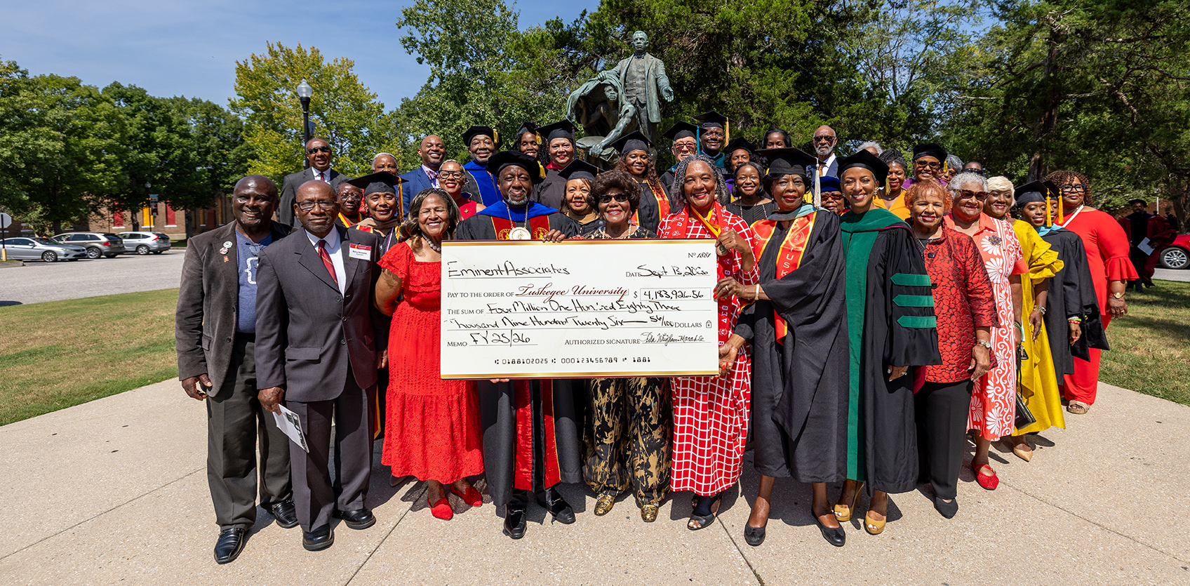 Eminent Associates pose with Dr. Brown and donation check at the BTW Monument