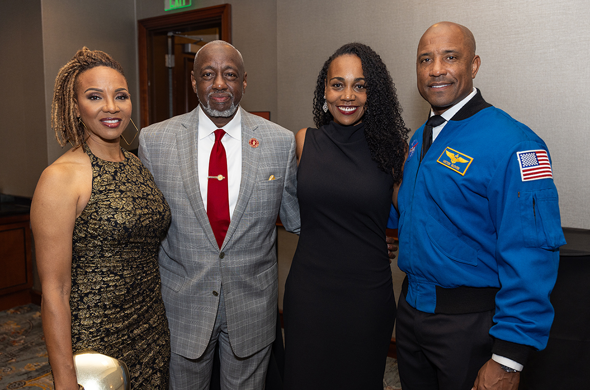 MC Lyte and TU President & CEO Dr. Mark A. Brown standing with NASA astronaut Capt. Victor Glover and his wife.