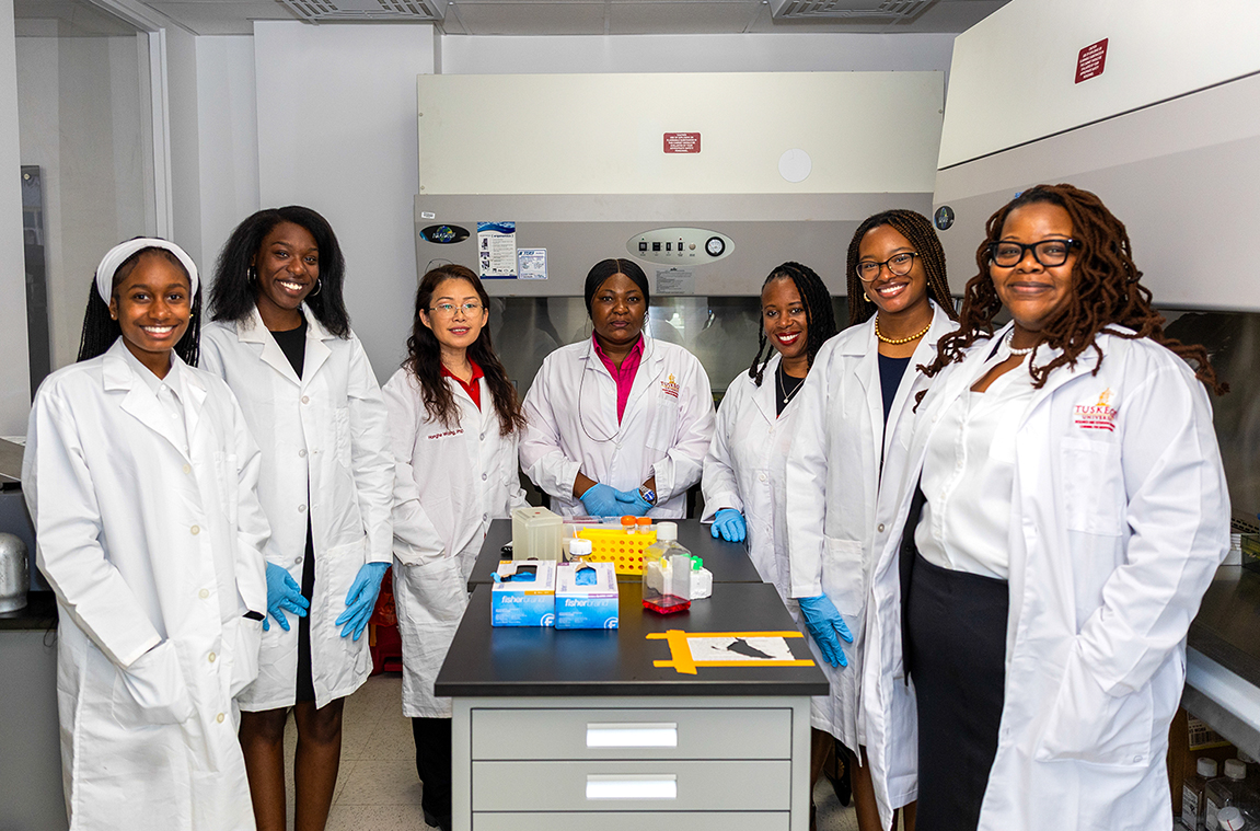Researchers in lab coats in a lab