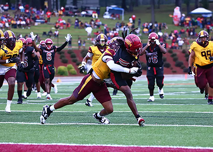 Players tackling at football game - Tuskegee University's first night game
