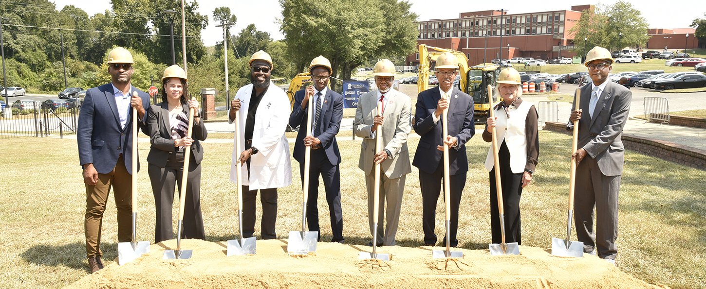 Picture of university and city officials and projects managers with shovels 